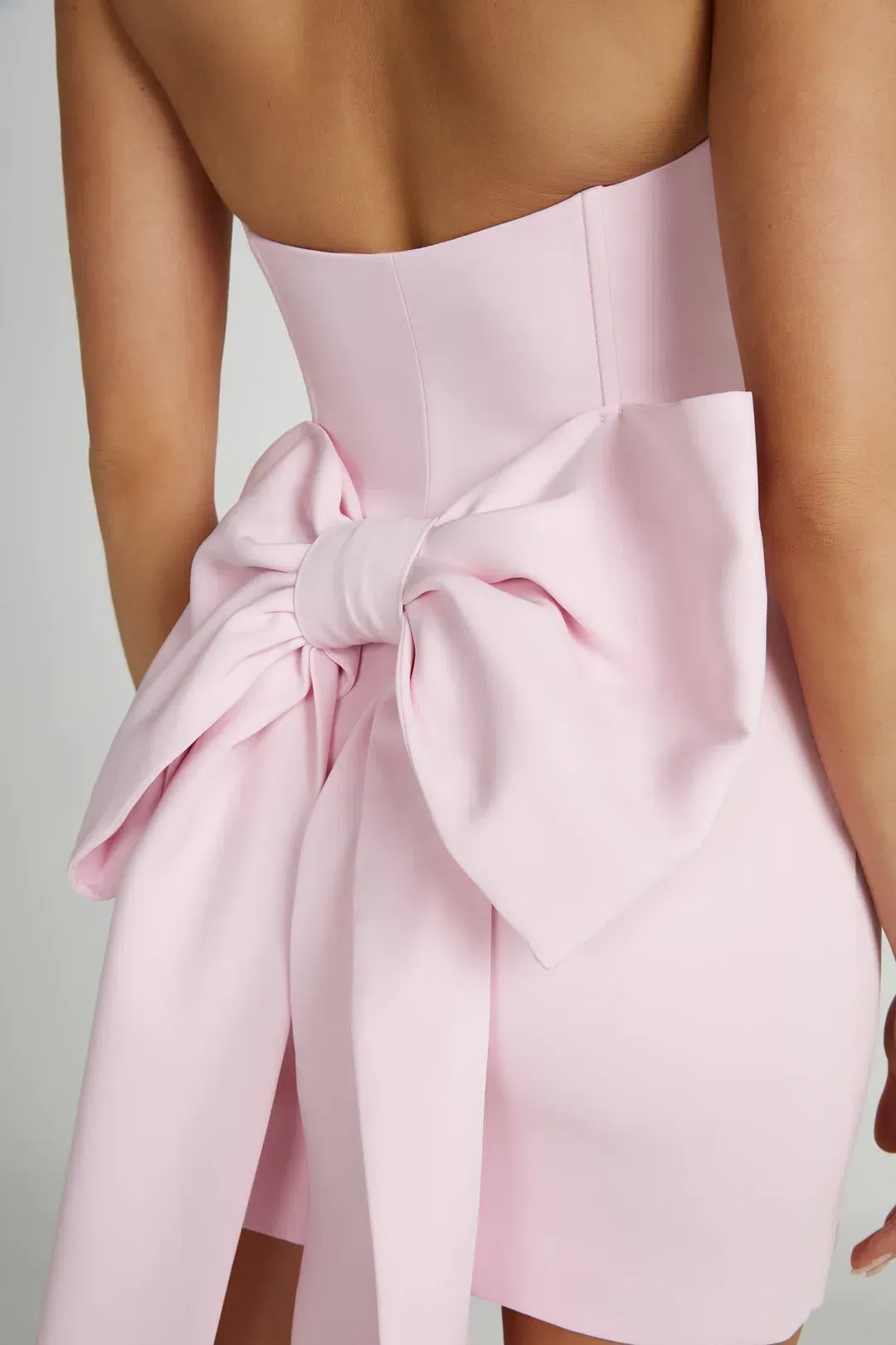 Meshki Meredith Strapless Bow Mini Dress in Blush Pink Size XS / AU 6 for rent on The Volte - main image