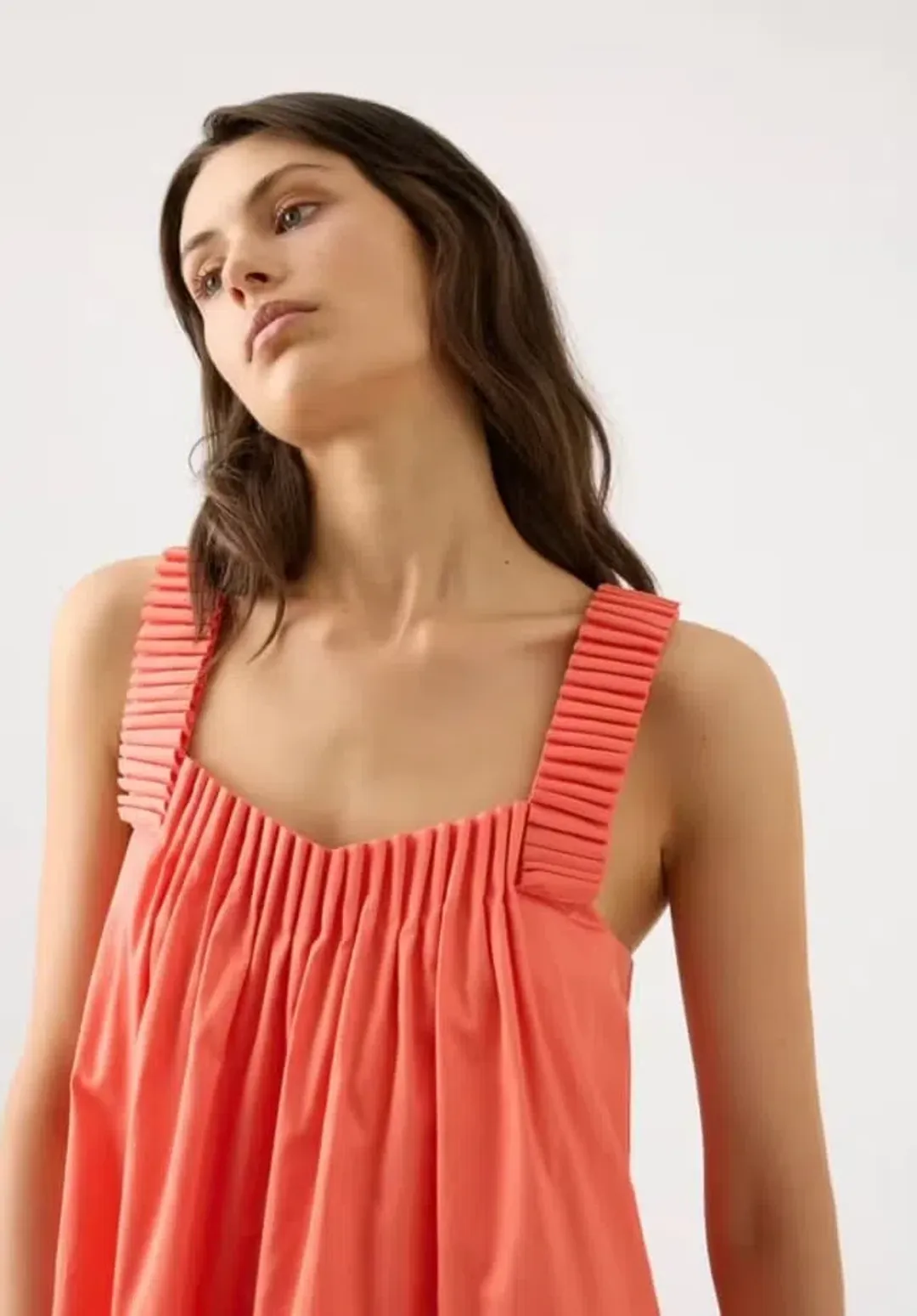 AJE CECILIA SMOCK MINI DRESS IN CORAL PEACH SIZE AU 6 for rent on The Volte - main image